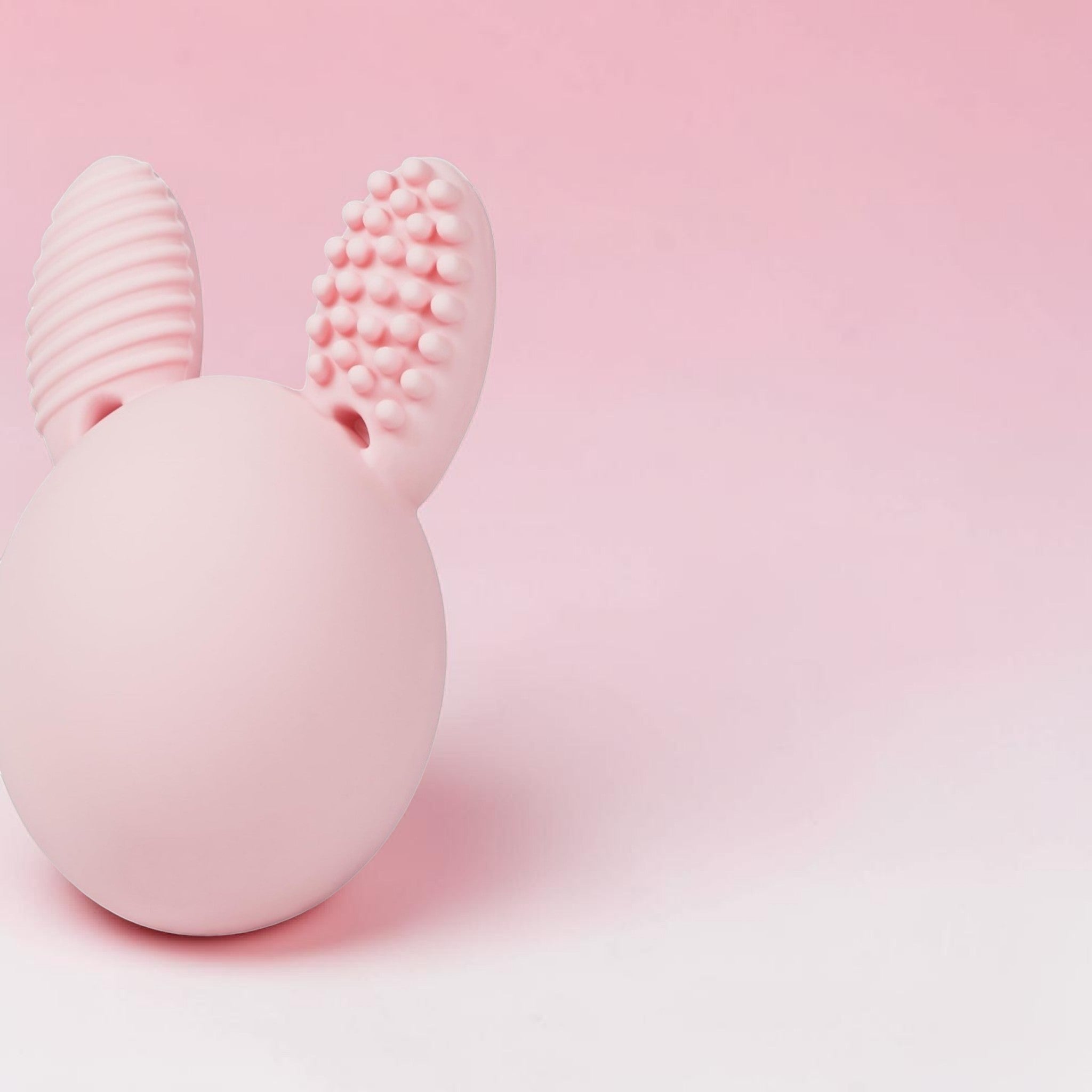 SwiftCart pink silicone bunny egg teether with textured ears for babies, aids teething and sensory play.
